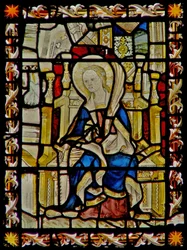 Östra fönstret som visar St Faith bärande hennes emblem sågen