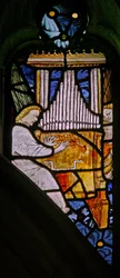 Fönster s1 föreställande musikeränglar med en orgel