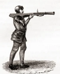En fotsoldat som använder en handbombard, sent 1300- och 1400-tal, efter en teckning från 1800-talet, från Les Merveilles de la Science, publicerad ca 1870 (gravyr)