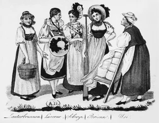 Schweiziska kvinnor i traditionell dräkt