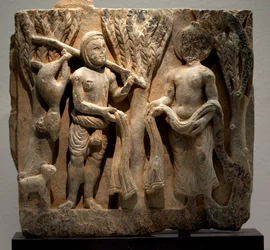 Klädbyte med en jägare. Skulpterad lågrelief, Gandhara-konst (Pakistan), 2:a-3:e århundradet. Koreas nationalmuseum, Seoul (Sydkorea).