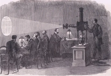 Läser ballongavgångar med mikroskop, Cassells historia om kriget mellan Frankrike och Tyskland publicerad av Cassell and Company Limited, ca 1890 (litho)