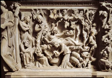Bebådelsen och födseln. Hög relief av marmor huggen