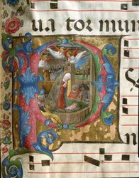 Lettrine P decoree föreställande miniatyren Nativite av Girolamo da Cremona (verksam omkring 1451-1483) från ett kor (kod 18/3) från katedralen i Siena. 1400-talskatedralen (Duomo) i Siena, Italien.