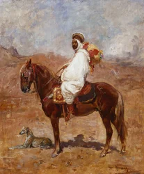 En arab på en häst i ett ökenlandskap