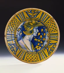 En Deruta-lustrad porträttskål målad i blått och lystrad i gult föreställande en krigare i en hjälm med en bevingad griffin, ca 1525