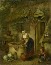 Kvinna hämtar vatten från en brunn