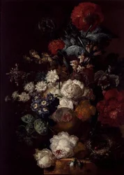 Stilleben med blommor och ett fågelbo