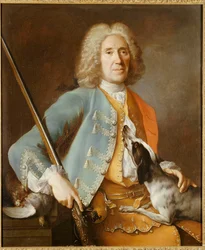 Porträtt av en idrottsman som håller en pistol med en hund