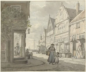 Kvinna och barn går på gatan i en fiskeby