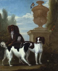 Tre spaniels vid en urna i ett skogslandskap