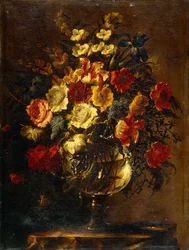 Blommor i en glasvas på en sten,