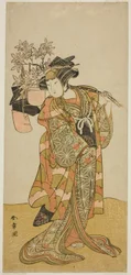 Skådespelaren Yamashita Kinsaku II som Odai, en Eboshi (hat)säljare, i pjäsen Hana-zumo Genji Hiiki, framförd på Nakamura Theatre i den elfte månaden, 1775