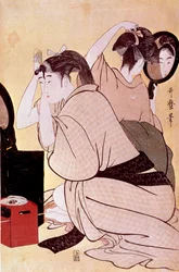 Två kvinnor ordnar sina frisyrer: Den ena betraktar sig i spegeln medan den andra kammar håret. Japanskt träsnitt av Kitagawa Utamaro (1753-1806). Mått: 0,38 x 0,25 m. 1794-1795. Paris, Musée Guimet, Nationella museet för asiatisk konst