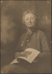 [Woman Holding Magazine]