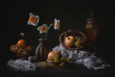 Stilleben med påskliljor och frukt