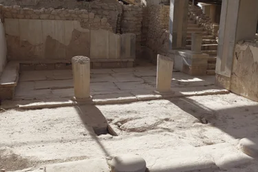 Minoiska arkeologiska platsen Phaistos. Drottningens Megaron (dvs. drottningens lägenheter). Den sydligaste av "" Royal Apartmentsof Phaistos. Golvet var belagt med gipsskivor och röd puts som fyllde mellanrummet. Gips användes också för thr benc