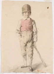 Stående pojke med en vagn i sin vänstra hand