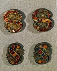 Medeltidens arkeologi (medeltiden). Barbarisk konst från Lombardiet: Bältesfibula (spänne) i form av bokstaven S. Objekt i guld och polykrom emalj. Lombardkonst, 6-700-tal. Italien, Cividale del Friuli, Arkeologiskt museum
