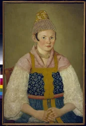 Porträtt av en köpmans fru, huvudbonad av den traditionella kokoshniken. (Porträtt av en köpman i Kokoshnik Kabluchok). Hon bär också den traditionella ryska klänningen (sarafane) dekorerad med broderier, med en blus med spetsärmar, hennes huvudbonad