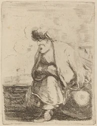 En gammal turk med turban som sitter på en sten