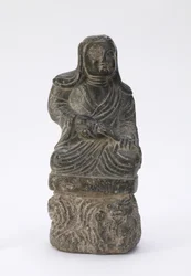 Liten staty av en buddhistisk präst