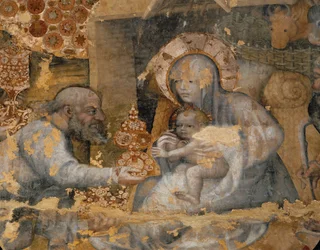 Madonna med barn, en av de tre heliga kungarna ger en gyllene bägare till barnet