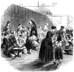 Lär flickor att läsa i Ragged School Union School, Lambeth, London, 1868