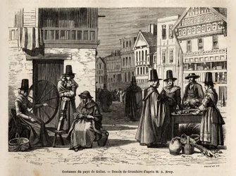 En gata i Wales, med lokalbefolkningen klädda i traditionella dräkter och vardagsaktiviteter: en förstahandsfamilj och kvinnor som spinner ull med hjul. Engravure pour illustrrer un voyage dans le pays de Wales, en 1862, par Alfred Erny, i "Le tour du mond