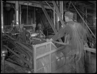 Arbetare som matar in timmer i en hyvel, Oneida, New York, 3 april 1916