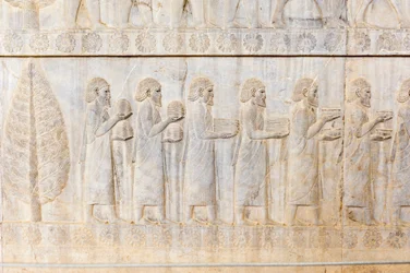 Forntida relief av Achaemeniderna; delegation av jonerna; Apadana-palatset; arkeologisk utgrävning; forntida persiska staden Persepolis; UNESCOs världsarvslista; Fars-provinsen; Iran; Asien